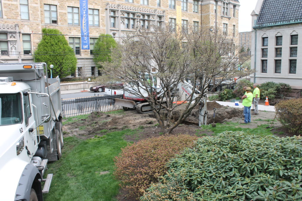Another viewpoint of the landscape being torn up during installation of rain barrels.